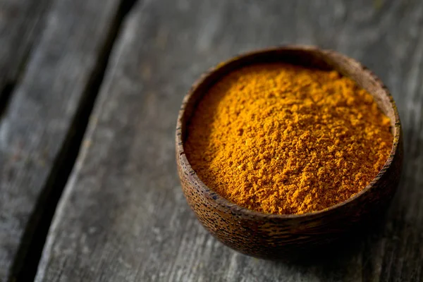curry powder on wooden surface