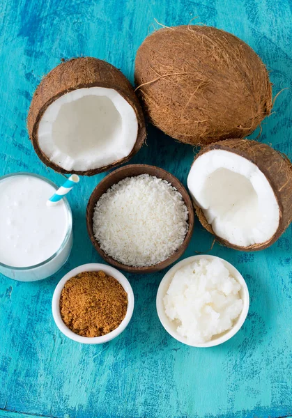 coconut sugar, milk and oil on wooden surface