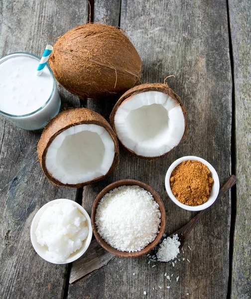 coconut sugar, milk and oil on wooden surface