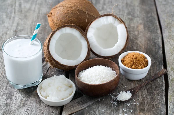 coconut sugar, milk and oil on wooden surface