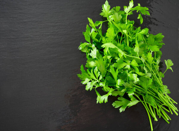 bunch of parsley on black chalkboard