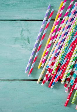 Turkuaz ahşap arka plan üzerinde renkli kağıt payet