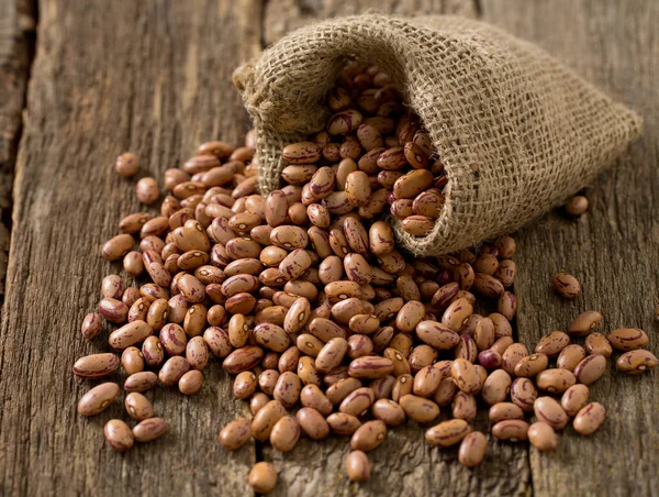 pinto beans on wooden surface