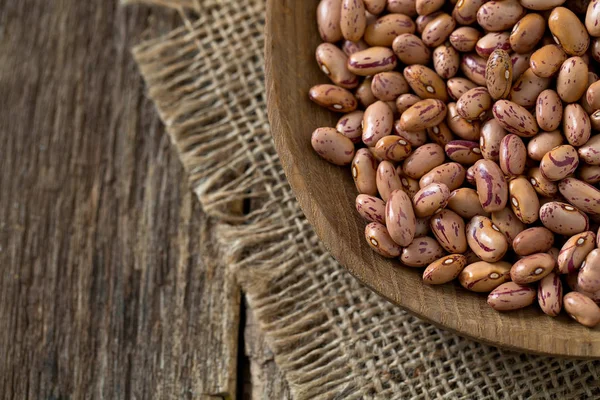 pinto beans on wooden surface