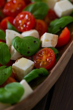 Koyu ahşap yüzeyde Caprese salatası