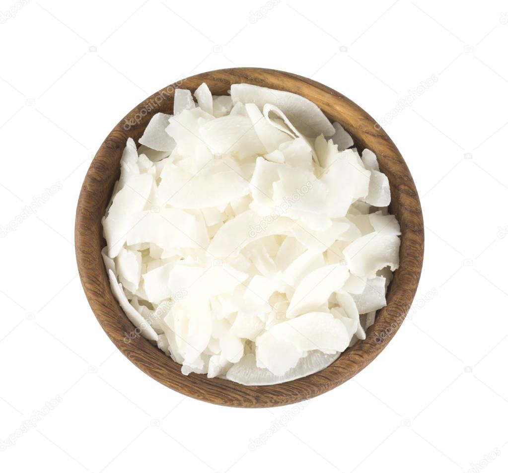 coconut flakes in a wooden bowl isolated on white