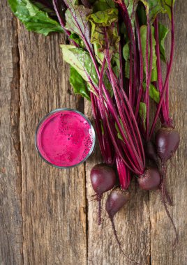 Beetroots ve ahşap yüzey üzerinde taze meyve suyu