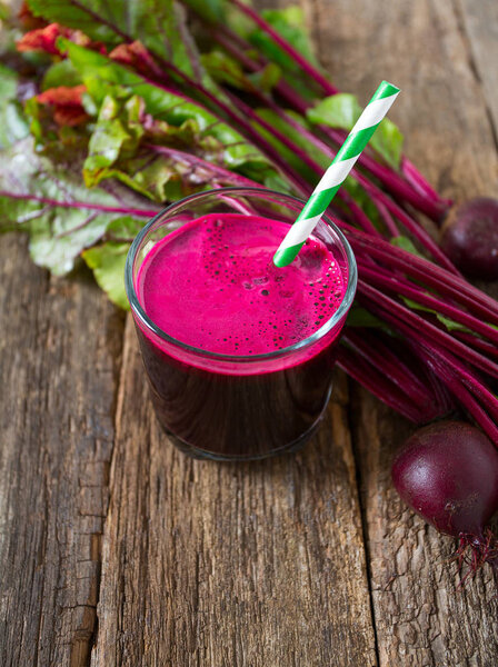 glass of fresh healthy beetroot juice on wooden surface
