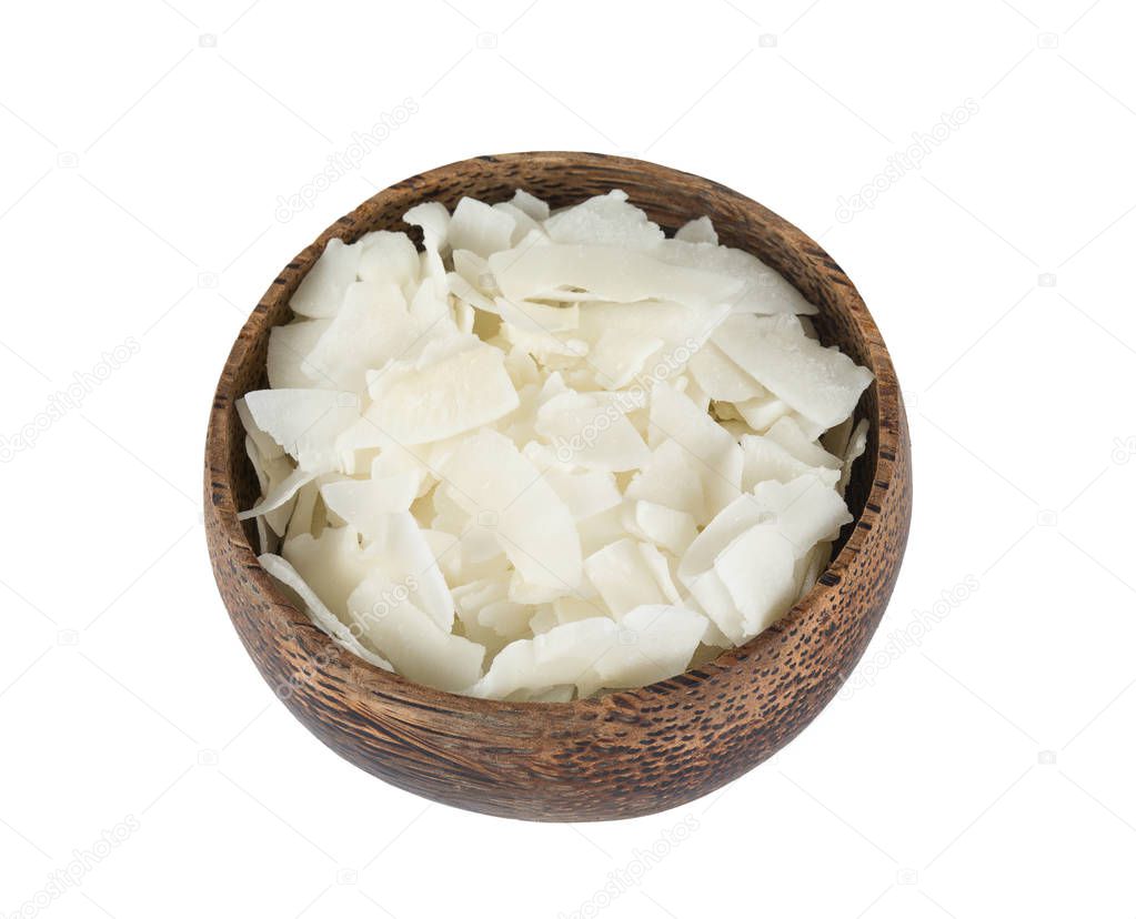 coconut flakes in wooden bowl isolated on white background