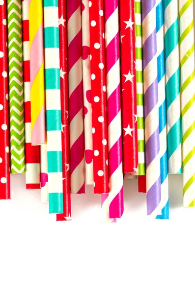 multicolored paper straws on white background