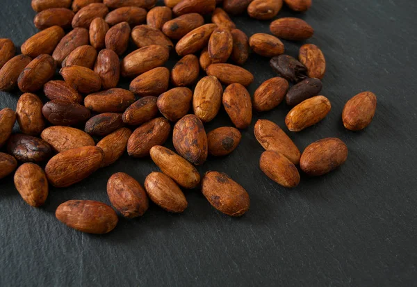 cocoa beans on chalkboard wall background close up