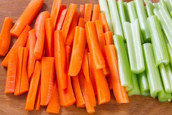 carrot and celery sticks isolated on white