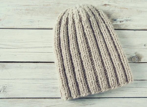 knitted hat on wooden surface