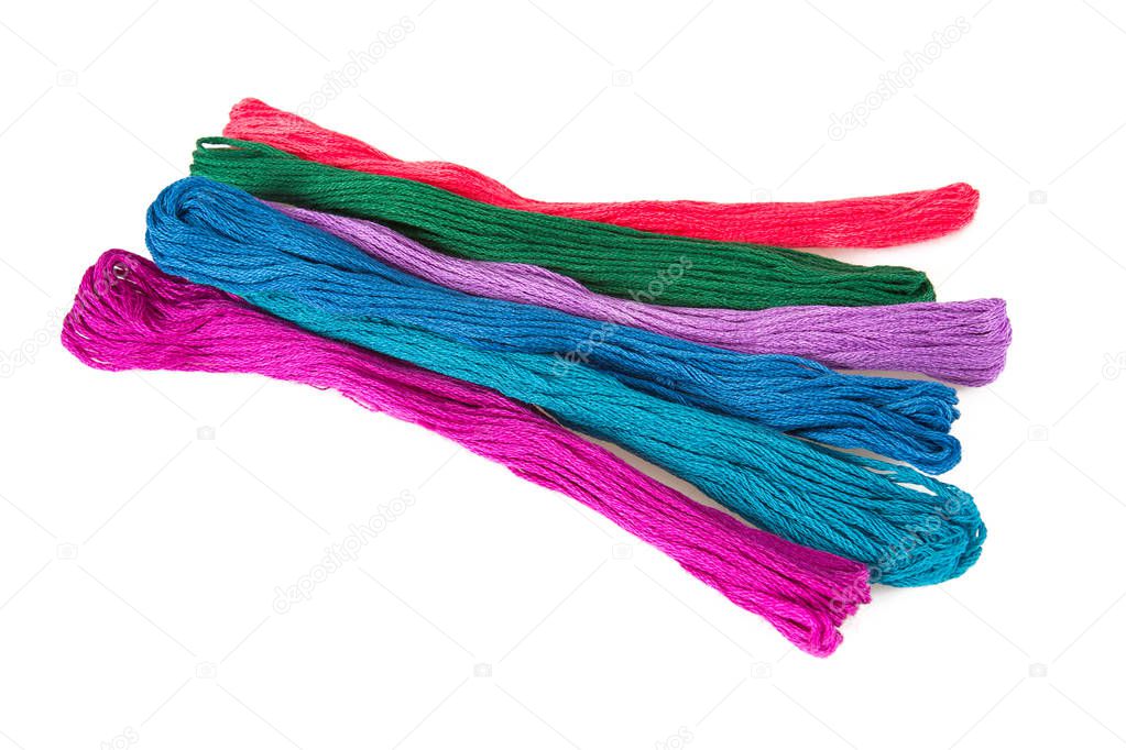 colorful sewing threads for embroidery isolated on white background