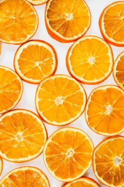 Kurutulmuş portakal dilimleri beyaz arkaplanda izole edilmiş.