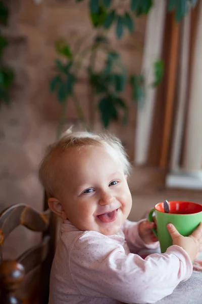 cute little girl drinking tea from her cup
