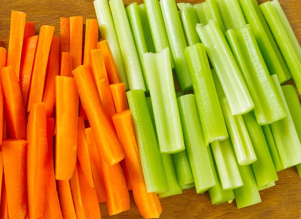 carrot and celery sticks isolated on white