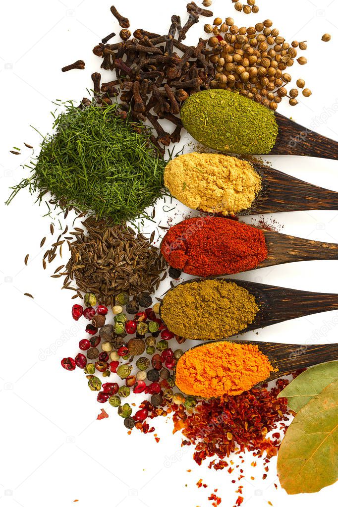 different spices on white background