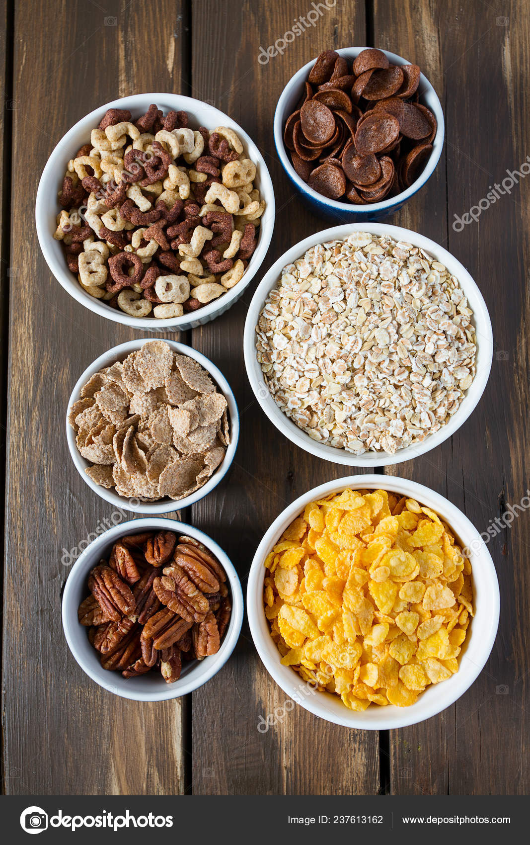 Various Cereals Nuts Dried Fruits Wooden Surface Stock Photo by