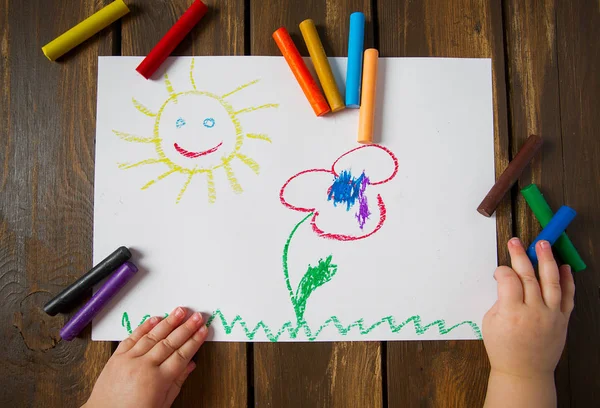 kid drawing on wooden table