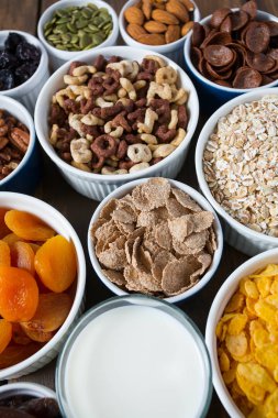 Tahta yüzeyde çeşitli tahıllar, fındıklar ve kurutulmuş meyveler.