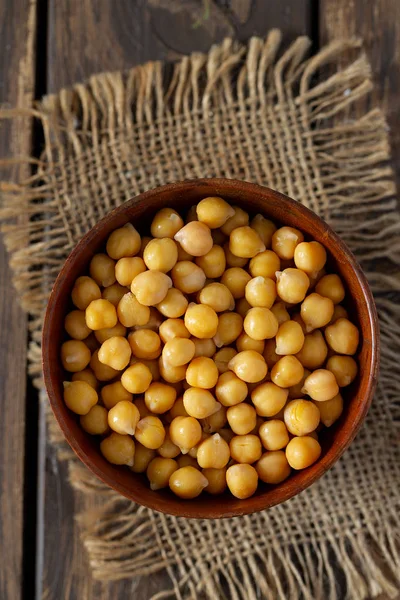 Chickpeas on blue wooden surface — Stock Photo, Image