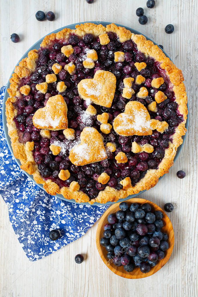 homemade blueberry pie on white wooden surface