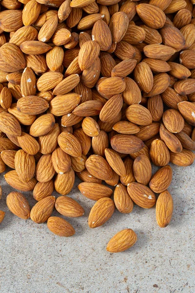 Almond nuts on granite background — Stock Photo, Image