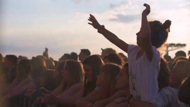 Slow motion sequence of hands of dancers at party shot against the sun. Shot on Sony FS700 at a frame rate of 100fps — Stock Video