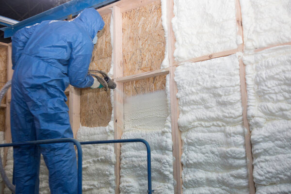 Foam is applied to the walls to warm the house