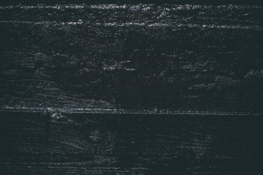 Çizik ve çatlaklarla kaplı siyah reçine duvar dokusu.