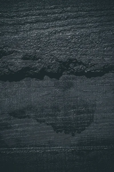 Black resin wall texture with scratches and cracks.