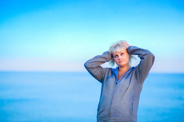 half body portrait of young woman enjoying breeze at beach