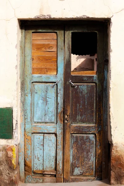 Photo closeup of old aged building made of stone masonry with aged wooden door