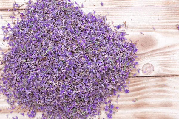 lavender dried scattered flowers on wooden background