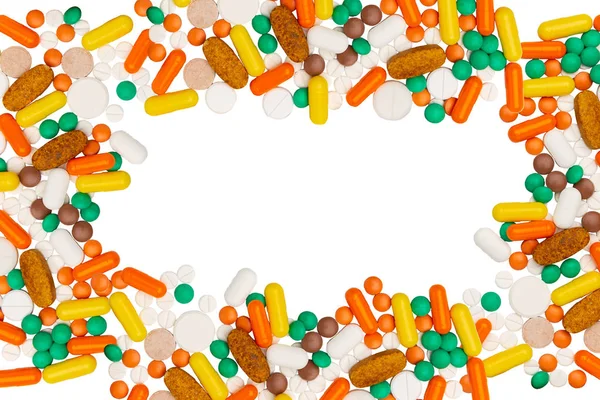 Píldoras de la droga cápsulas de diferente color y marco de forma en blanco — Foto de Stock