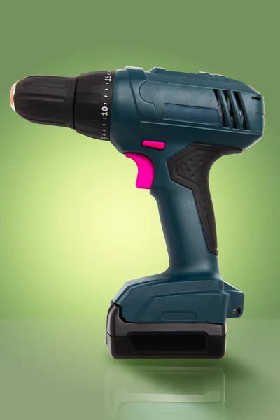 Cordless battery drill on gradient green with pink buttons — Stock Photo, Image