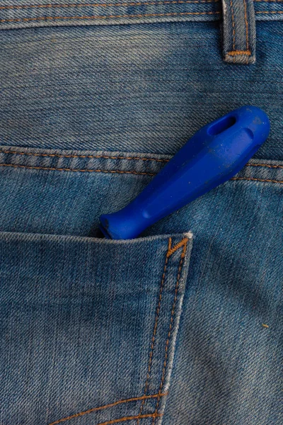 Screwdriver tool in blue jeans pocket — Stock Photo, Image