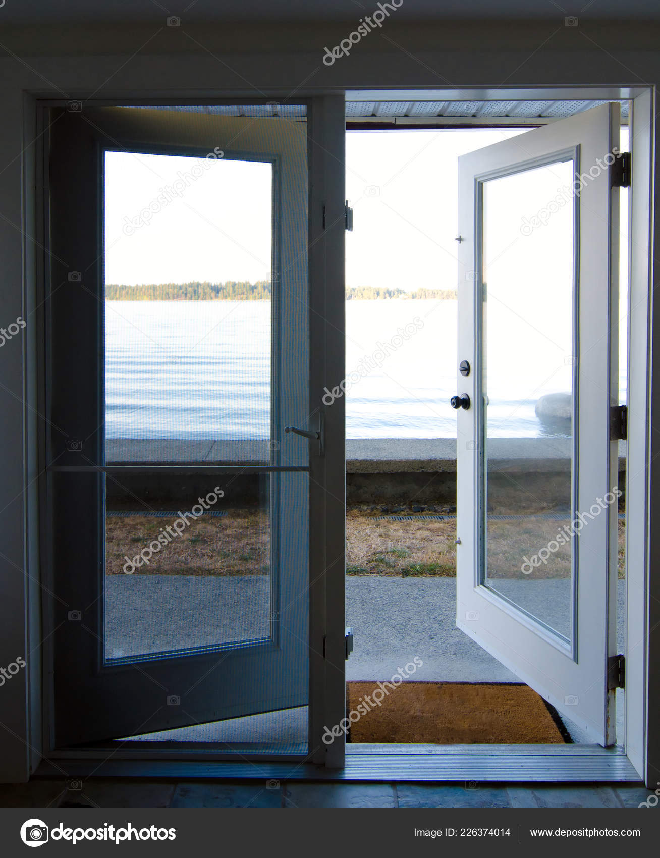 Opened French Doors Leading Beach Saanich Inlet British Columbia Opened French Doors Leading Beach Saanich Inlet British Columbia Stock Photo