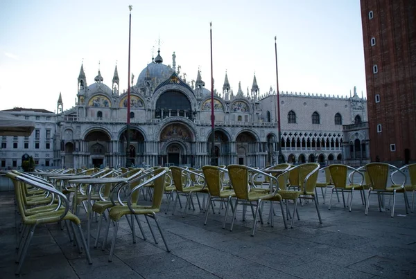 Yellow chairs in street cafe on San Marco square, Venice