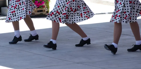 Tap dansare i kjolar med blommiga ornament — Stockfoto