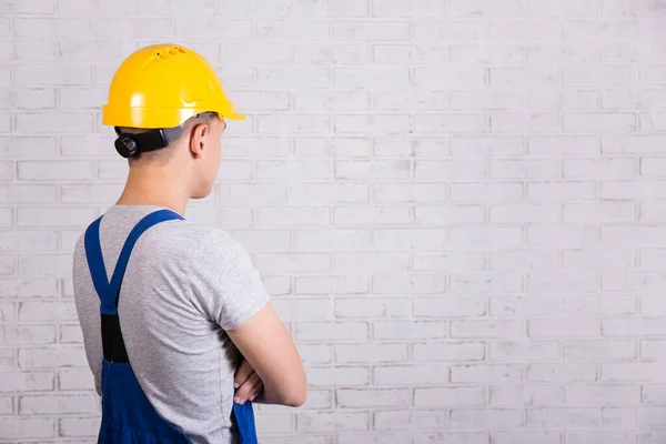 Back View Man Blue Builder Uniform Looking White Brick Wall — Stock Photo, Image