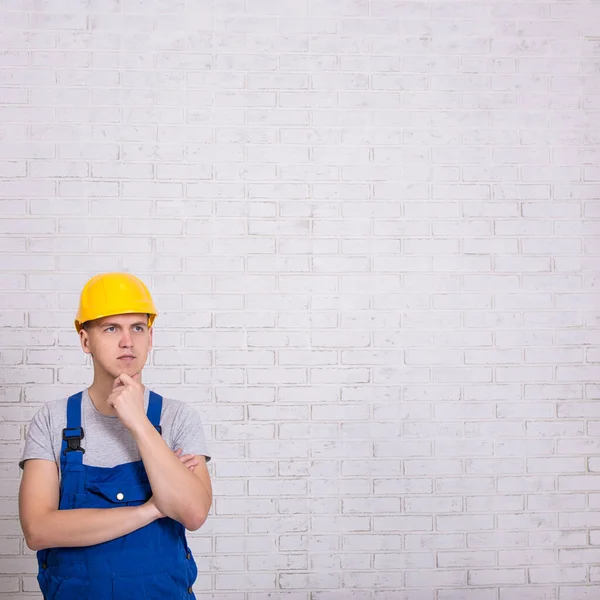 Builder Uniform Copy Space White Brick Wall — Stock Photo, Image