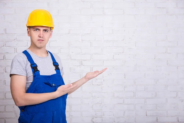Portrait Builder Uniform Pointing Copy Space White Brick Wall — Stock Photo, Image