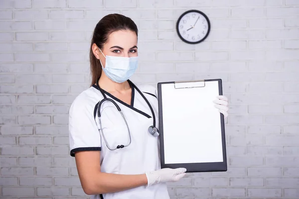 Dokter Wanita Bertopeng Memegang Papan Klip Dengan Kertas Kosong Kantor — Stok Foto