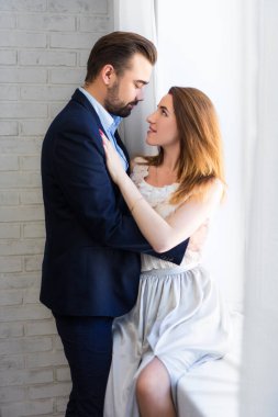 Aşk ve ilişki kavramı. Genç ve güzel bir çift evde öpüşüyor.