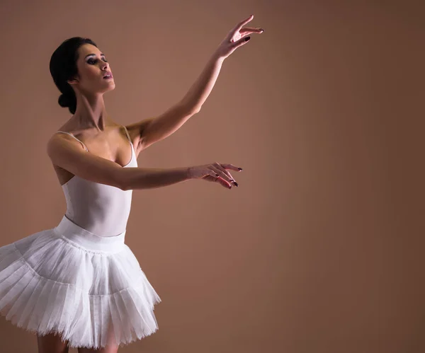 young beautiful woman ballet dancer dancing in white tutu