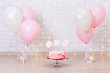 Doğum günü kutlaması konsepti - Tuğla duvar arkasında pasta ve renkli balonlar