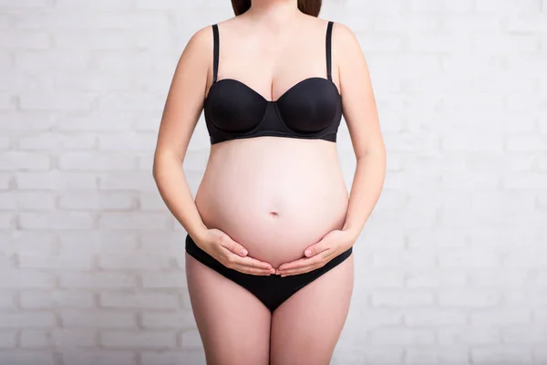 Close Pregnant Woman Black Lingerie Touching Her Belly White Brick — Stock Photo, Image