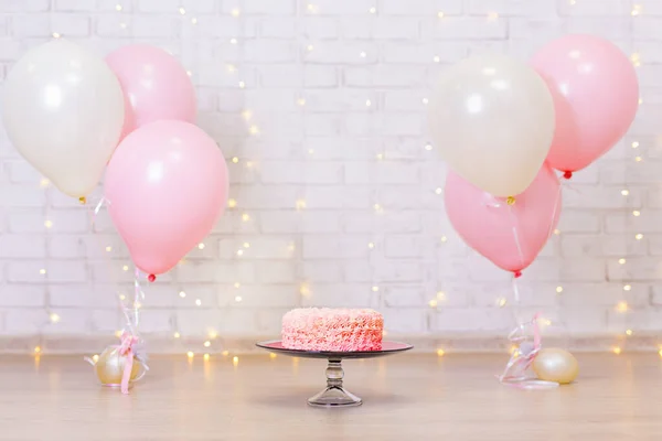 Birthday Celebration Background Pink Cream Cake Brick Wall Lights Balloons — Stock Photo, Image